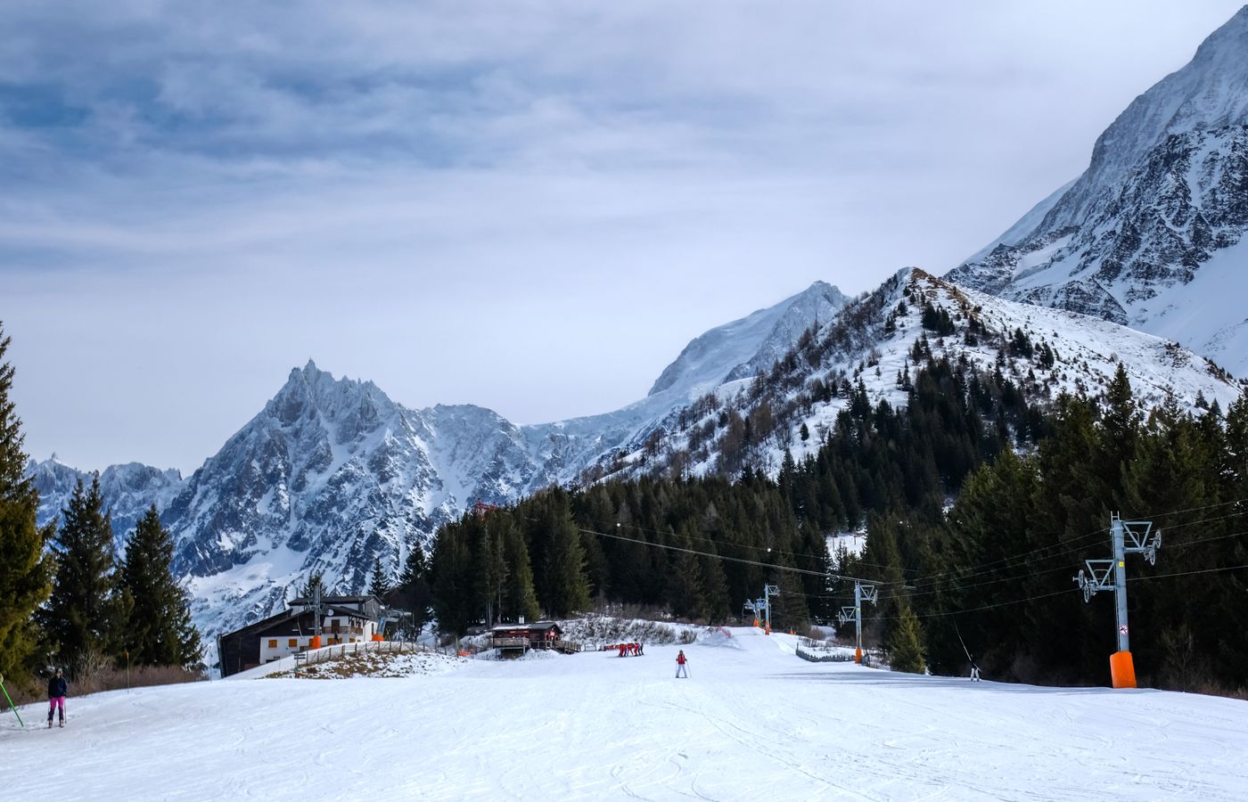 Ski slopes below snow-covered Alpine peaks