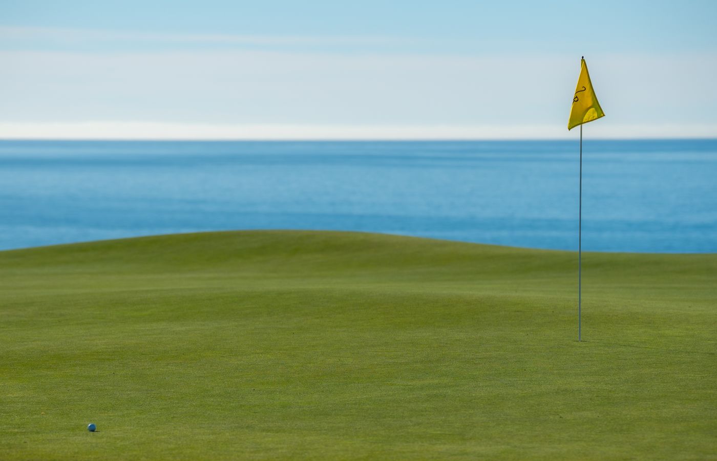 A green coastal golf course overlooking the ocean